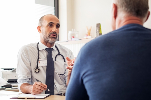 Doctor giving advice to a head and neck patient