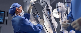 Care team member handles da Vinci system arm